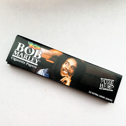 BOB MARLEY King Size Slim Rolling Papers (Various Designs), smiling, chin resting on his hand